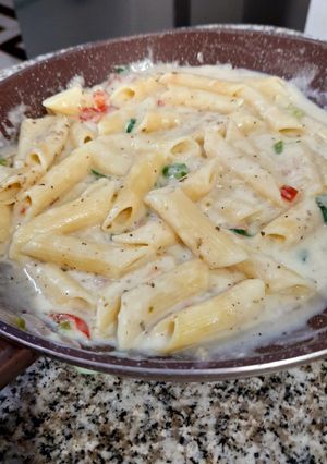 A picture of Penne in white sauce.
