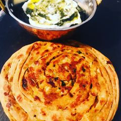 A picture of Potato masala stuffed lachha paratha.