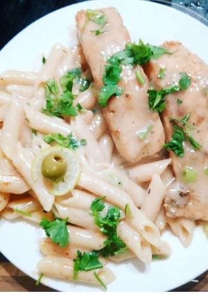 A picture of White sauce salmon and pasta.