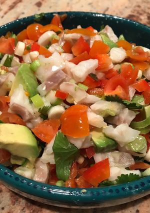 A picture of Ceviche with avocado, cherry tomatoes and spring onions.
