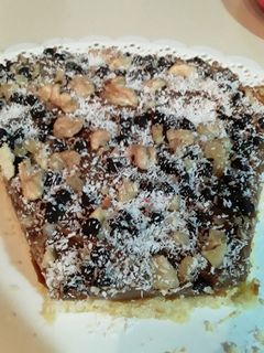 Una foto de Tarta de Dulce de leche chips de🍫 Nueces y Coco😁😍