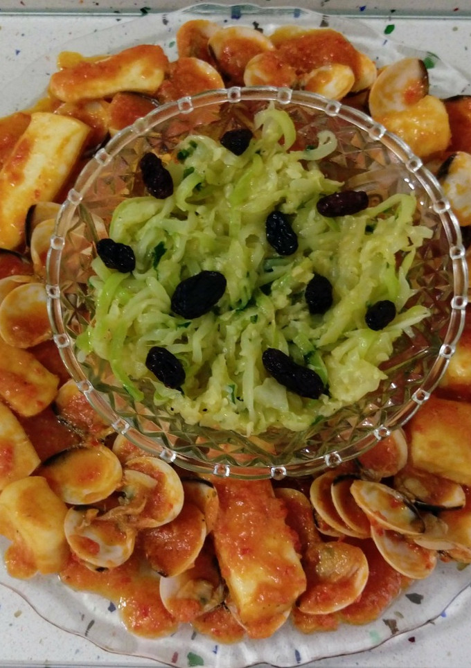 Una foto de Chocos y almejas a la marinera con salteado de calabacines con pasas