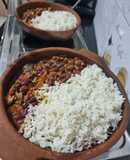 Beans and rice sizzler in a clay pan