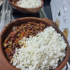 Beans and rice sizzler in a clay pan A picture of Beans and rice sizzler in a clay pan.