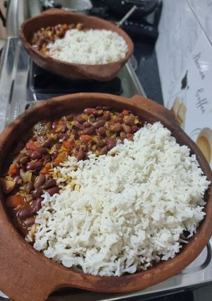 A picture of Beans and rice sizzler in a clay pan.