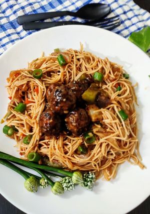 A picture of Veg noodles with manchurian.