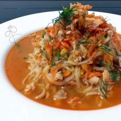 A picture of Salmon And Spiced Carrot On Ramen Noodle Soup.