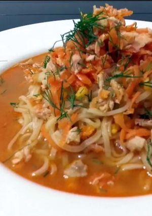 A picture of Salmon And Spiced Carrot On Ramen Noodle Soup.