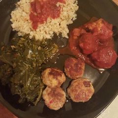 A picture of Cajun chicken meatballs with kale & collard green a brown rice.