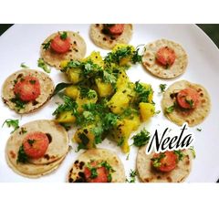 A picture of Aloo sabzi with mini chapati bites.