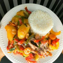 A picture of White rice with chicken shrimps in potatoes mixed veggies sauce.