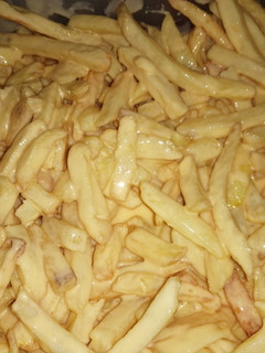Una foto de Papas fritas con salsa cheddar