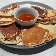 A picture of Scotch Pancakes with Warm Maple Syrup.