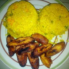A picture of Tumeric rice and fried plantain.