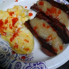 A picture of Spicy applesauce and sausage with eggs.