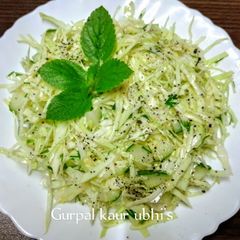 A picture of Young cabbage salad with cucumber.