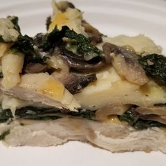 A picture of Chicken with spinach and mushrooms.
