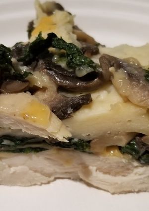 A picture of Chicken with spinach and mushrooms.