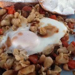 A picture of Popped breakfast beans w tomatoes and egg.