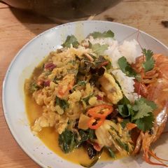 A picture of Fish curry with coconut + turmeric.