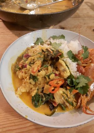 A picture of Fish curry with coconut + turmeric.