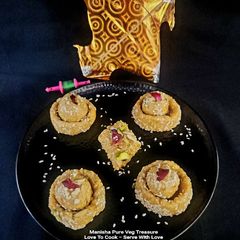 A picture of Til Ladoo In Til Katori - Sesame Ball In Seasame Cup.