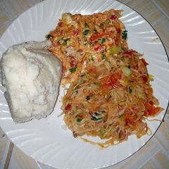 A picture of Fried Eggs, stewed Cabbages and Ugali.