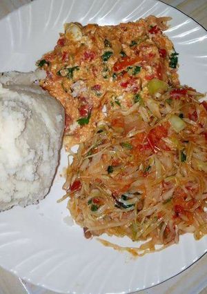 A picture of Fried Eggs, stewed Cabbages and Ugali.
