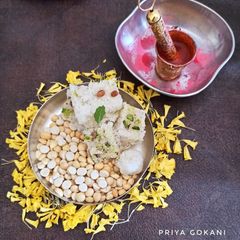 A picture of Coconut Barfi served with Roasted Chana Dal or Dalia.