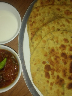 A picture of Besni masala prahta with tomato souce.