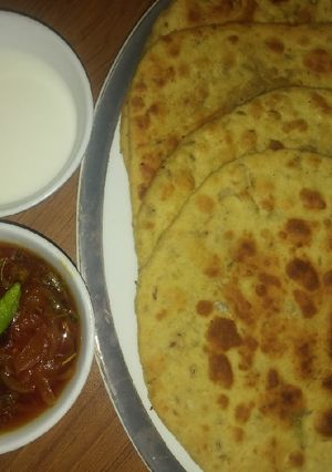 A picture of Besni masala prahta with tomato souce.