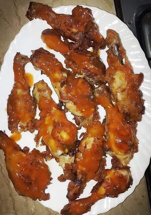 A picture of Hot Chicken legs with Red Sauce.