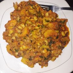 A picture of Delicious beans and ripe plantain porridge with scent leaves.