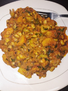 A picture of Delicious beans and ripe plantain porridge with scent leaves.