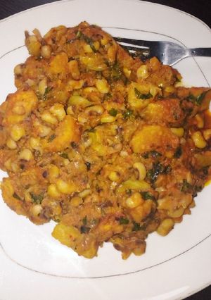 A picture of Delicious beans and ripe plantain porridge with scent leaves.
