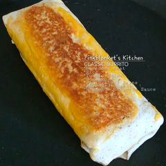 A picture of Classic Cheesy Shredded Meat Burrito with Homemade Creamy Chipotle Sauce.