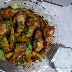 A picture of Spicy chicken wings sweet potato wedges coriander n lime yogurt.
