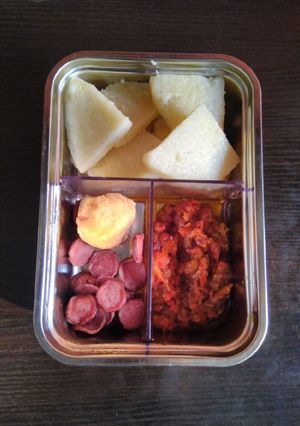 A picture of Yam, tomato sauce, sausage and chicken breast.