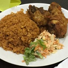 A picture of Jollof rice,fried chicken and coleslaw.