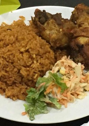 A picture of Jollof rice,fried chicken and coleslaw.