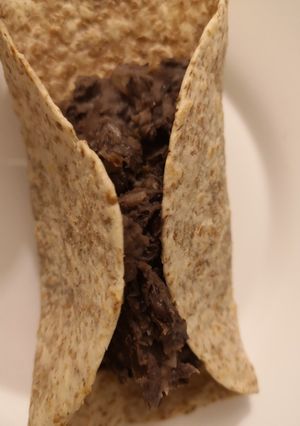 Una foto de Caraotas o frijoles negros refritos