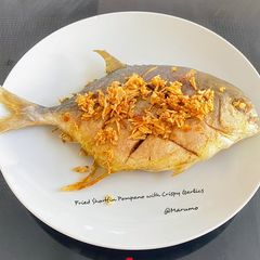 A picture of Fried Shortfin Pompano with Crispy Garlics.