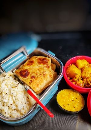 A picture of Lunch box (Jeera rice,ajwain paratha, pili dal, gobhi aloo sabzi.