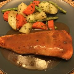 A picture of Grilled Salmon with Herbs Gravy and mixed veggies.