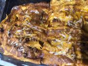 A picture of enchiladas with velveeta cheese