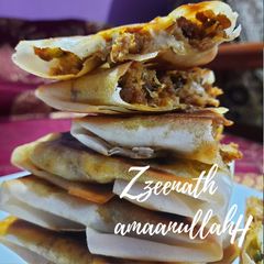 A picture of Arabic Mutabbaq with Spring Rolls.