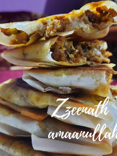 A picture of Arabic Mutabbaq with Spring Rolls.