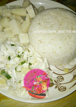 A picture of White rice, yam and cabbage with cucumber.