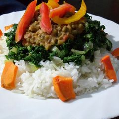 A picture of Rice with ndengu and buttered spinach.