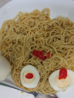 A picture of Indomie with boiled eggs.